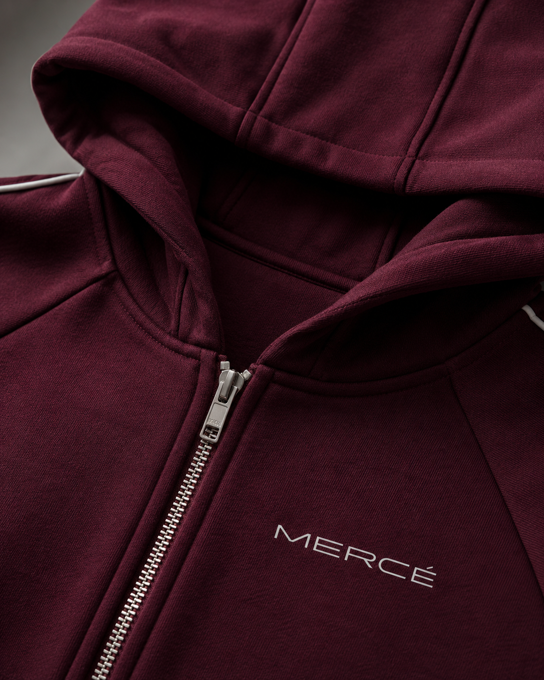 Close-up of MERCÉ hoodie zipper and heavyweight cotton texture