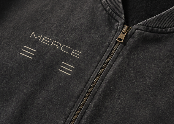 Close-up of MERCÉ varsity jacket texture and washed outerwear detailing